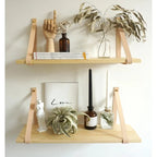 Brown wood wall shelf hung from two leather straps