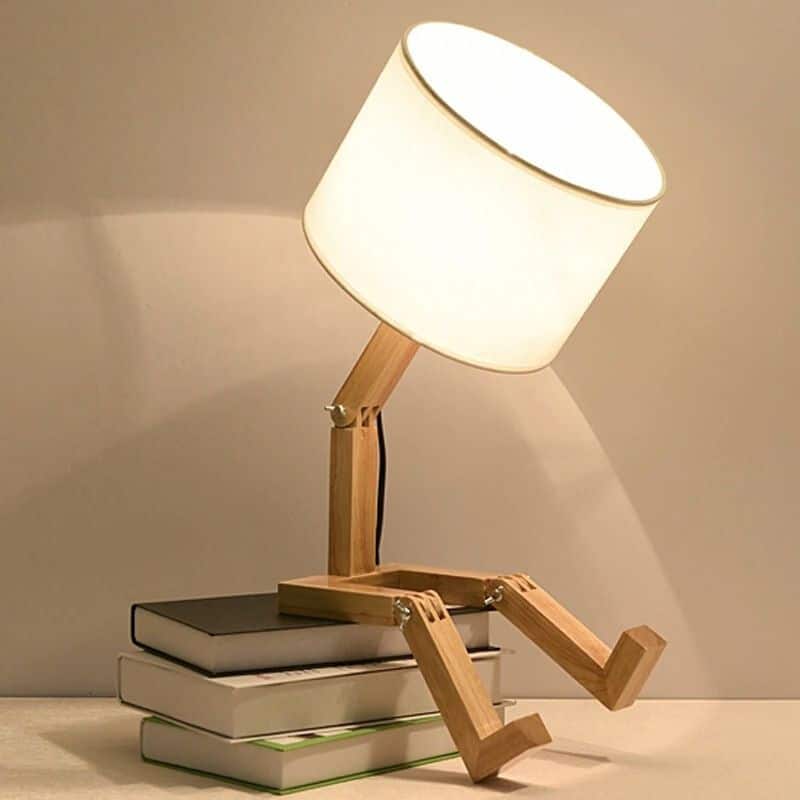 Playful wooden robot shaped bedside lamp with a fabric shade