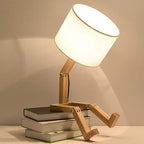 Playful wooden robot shaped bedside lamp with a fabric shade
