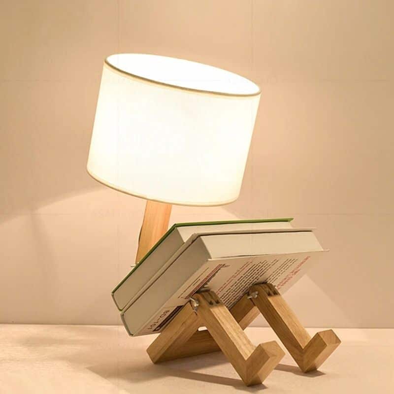 Playful wooden robot shaped bedside lamp with a fabric shade