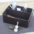 Woven rectangular organizer with four compartments holding toiletries