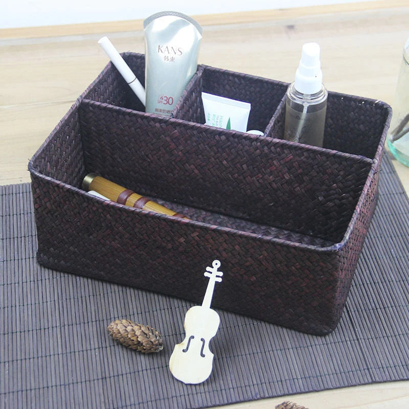 Woven rectangular organizer with four compartments holding toiletries