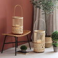 Hand woven natural bamboo lantern casting graphic patterns