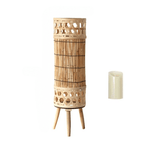 Tall woven bamboo floor lantern with an electric candle inside