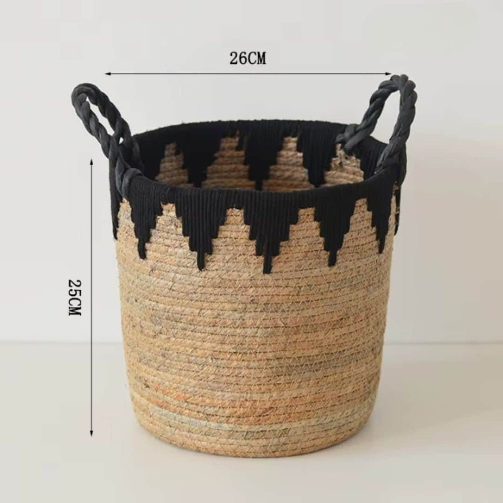 Woven basket with black zigzag pattern and black handles