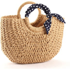 Hand woven beach bag with a knotted navy and white polka dot scarf handle