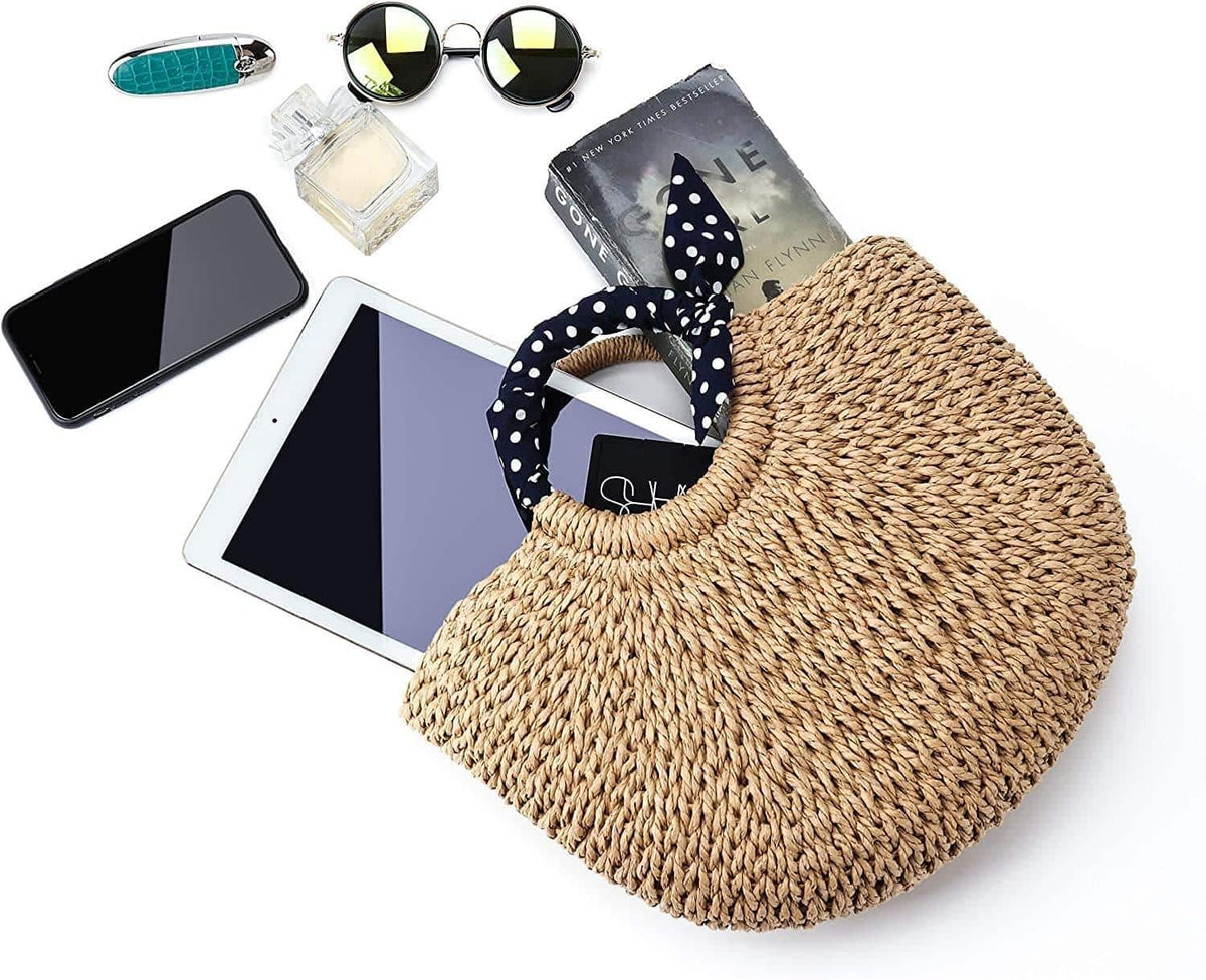 Hand woven beach bag with a knotted navy and white polka dot scarf handle