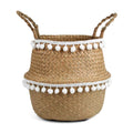 Woven belly basket trimmed with white pom poms