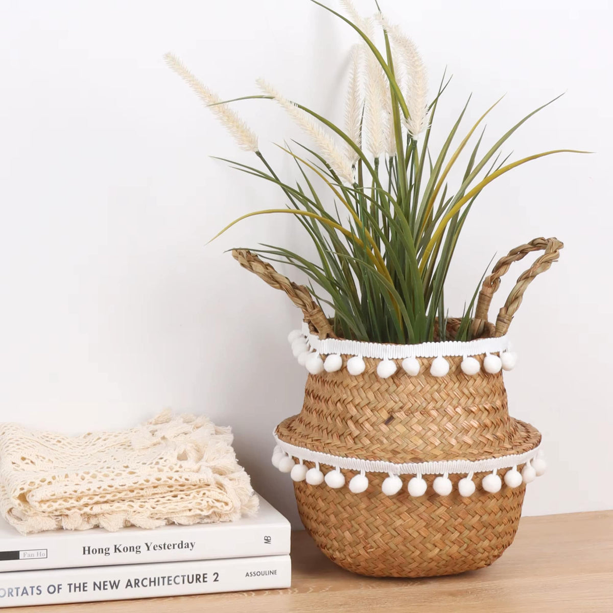 Woven belly basket trimmed with white pom poms