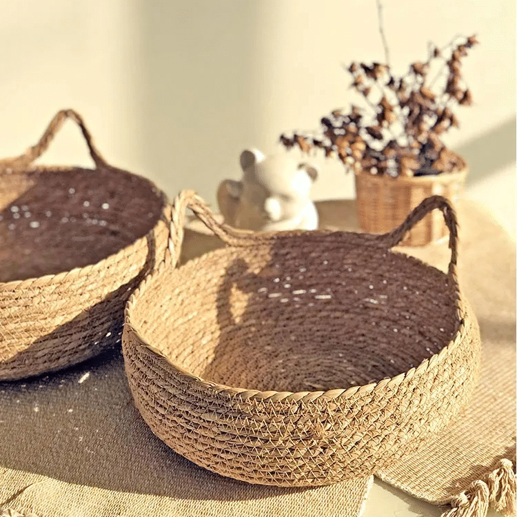 Cat curled up in a round woven cat bed with ears