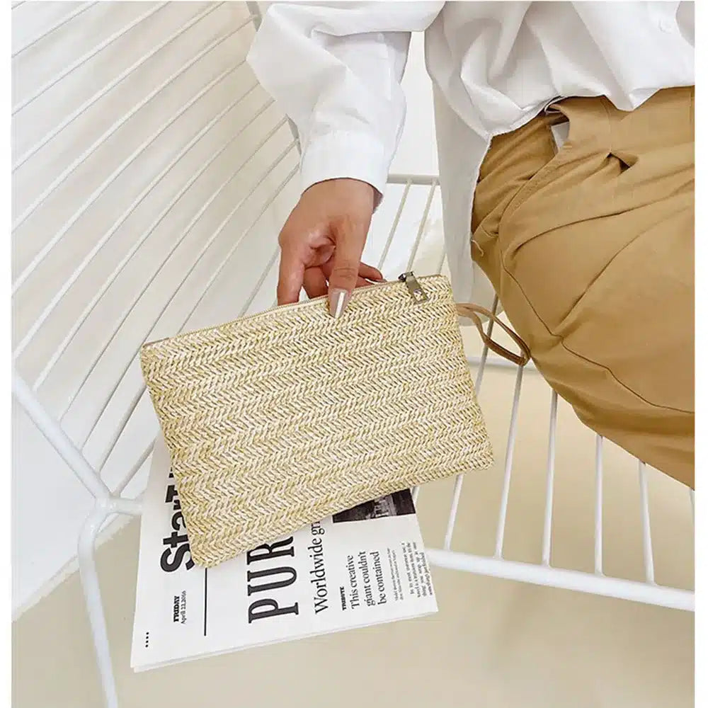 Compact beige woven clutch with a brown shoulder and wrist strap