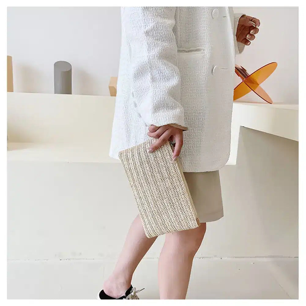 Compact beige woven clutch with a brown shoulder and wrist strap