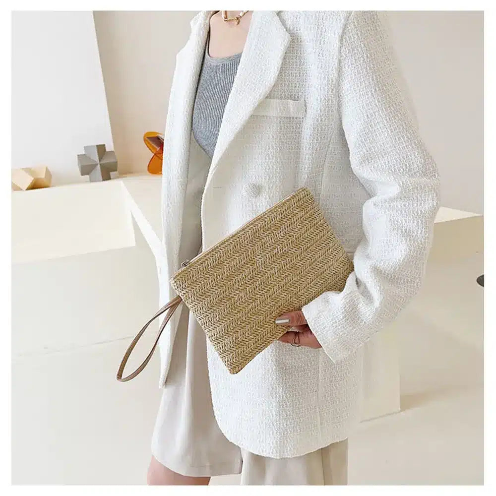 Compact beige woven clutch with a brown shoulder and wrist strap