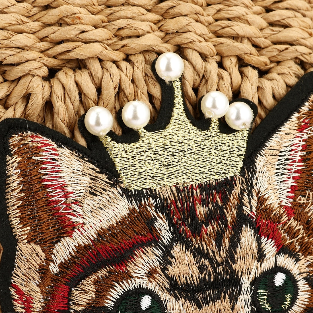 Woven clutch with a cat motif worked into the weave and a zip