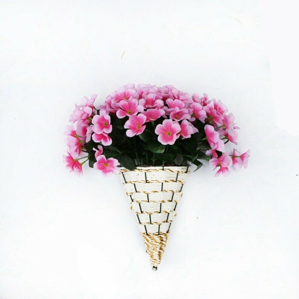 Woven cone shaped wall planter filled with pink flowers