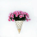 Woven cone shaped wall planter filled with pink flowers