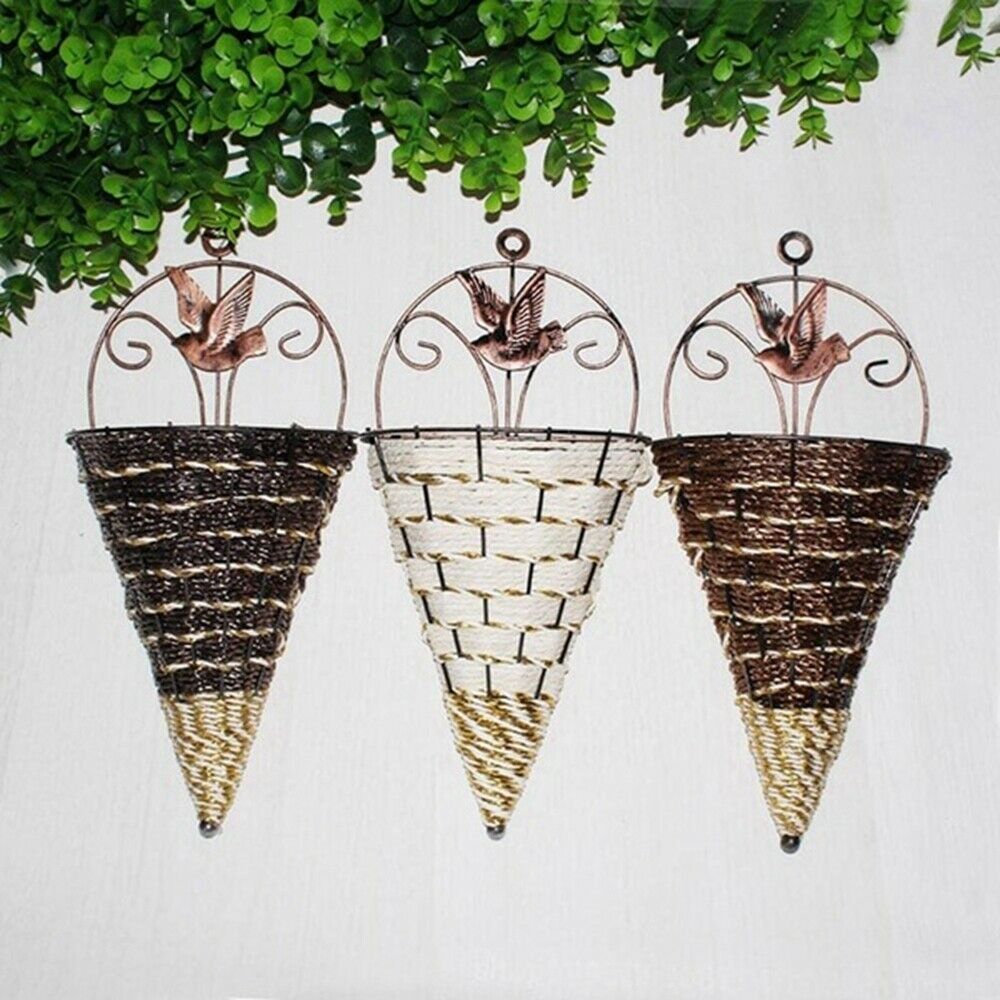 Woven cone shaped wall planter filled with pink flowers