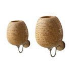 Two woven egg shaped wall sconces on curved arms