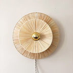Round woven flower wall sconce with a brass center
