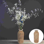 Glass bottle vase wrapped in an open woven wicker net