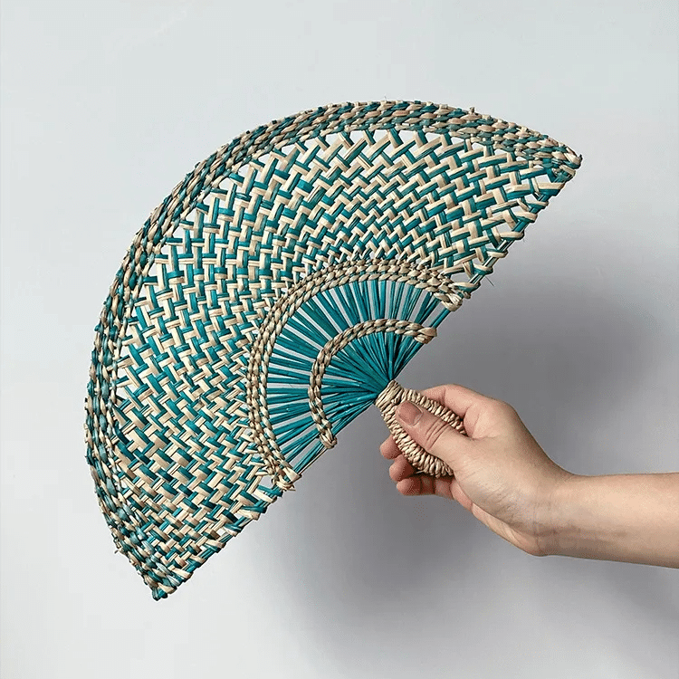Half moon woven hand fan with colored radiating ribs and a loop handle