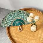 Half moon woven hand fan with colored radiating ribs and a loop handle
