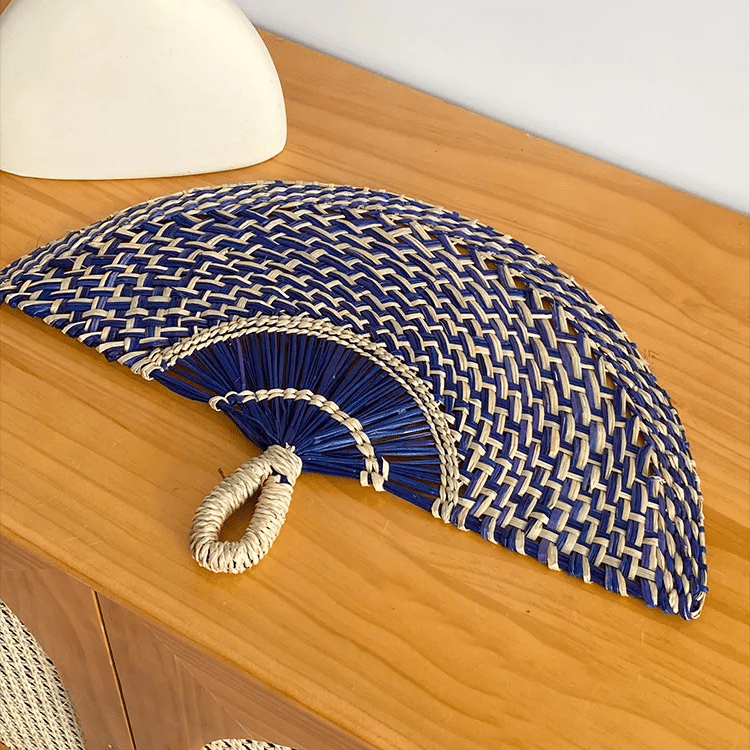 Half moon woven hand fan with colored radiating ribs and a loop handle