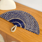 Half moon woven hand fan with colored radiating ribs and a loop handle