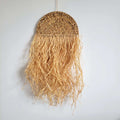 Woven half moon wall hanging with long raffia fringe