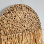 Woven half moon wall hanging with long raffia fringe