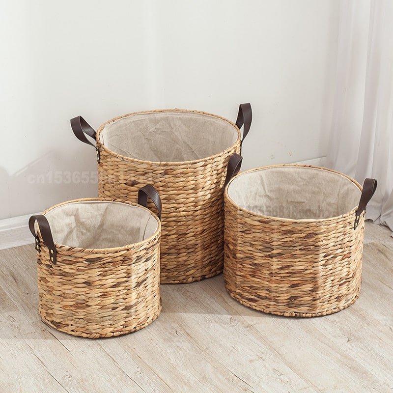 Round woven laundry basket with leather look handles and liner