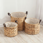 Round woven laundry basket with leather look handles and liner