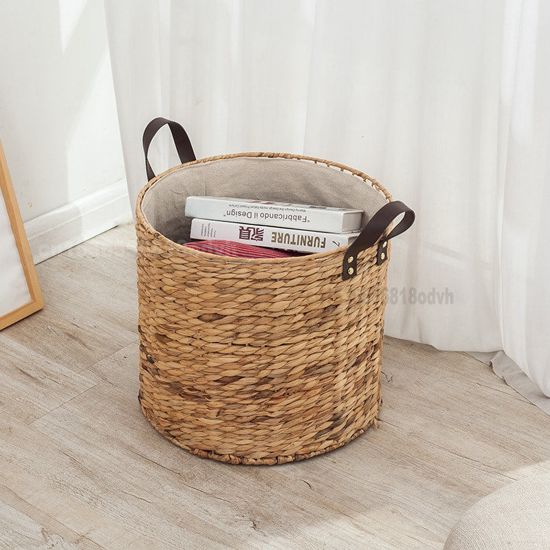 Round woven laundry basket with leather look handles and liner