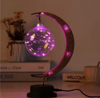 Crescent moon lamp with a hand woven hemp frame and a round blush pink globe