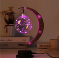 Crescent moon lamp with a hand woven hemp frame and a round blush pink globe