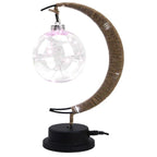 Crescent moon lamp with a hand woven hemp frame and a round blush pink globe