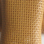 Brown hand woven PE rattan neck cushion with a curved shape