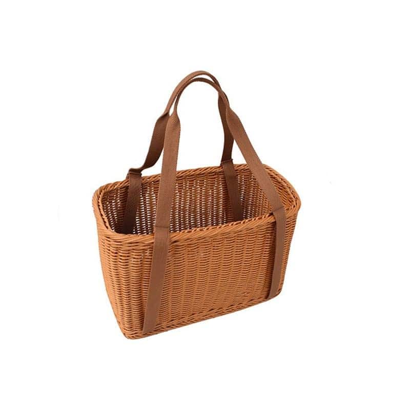 Two woven picnic tote baskets with soft handles on a picnic blanket