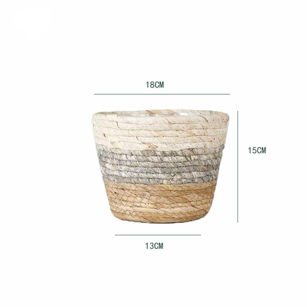 Woven plant pot covers with liners holding green plants