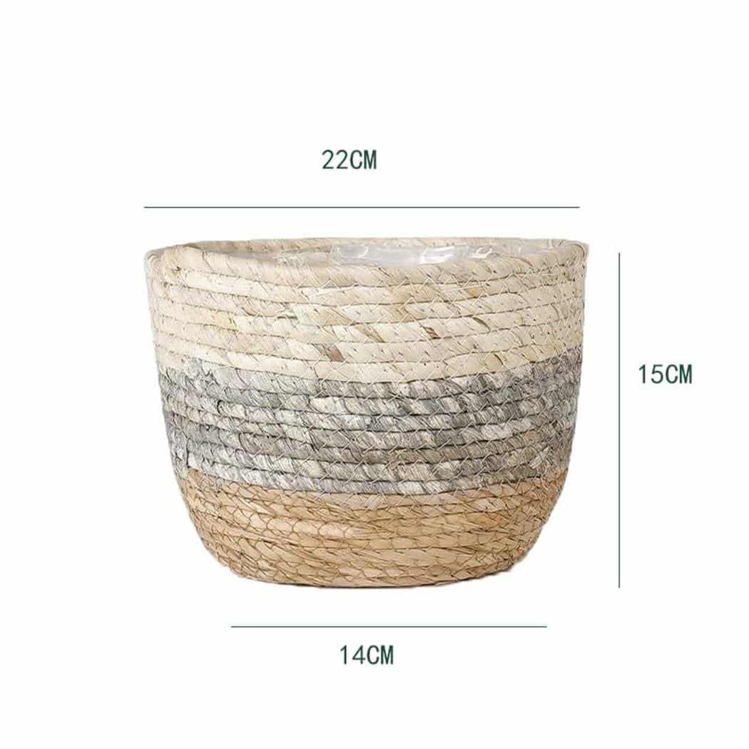 Woven plant pot covers with liners holding green plants