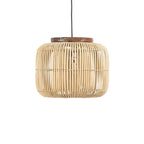 Woven rattan drum pendant light hung in a rustic room