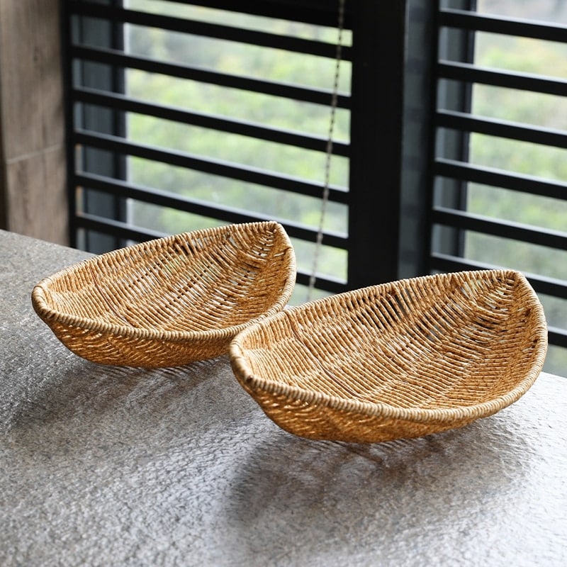 Boat shaped hand woven rattan fruit basket on a kitchen counter