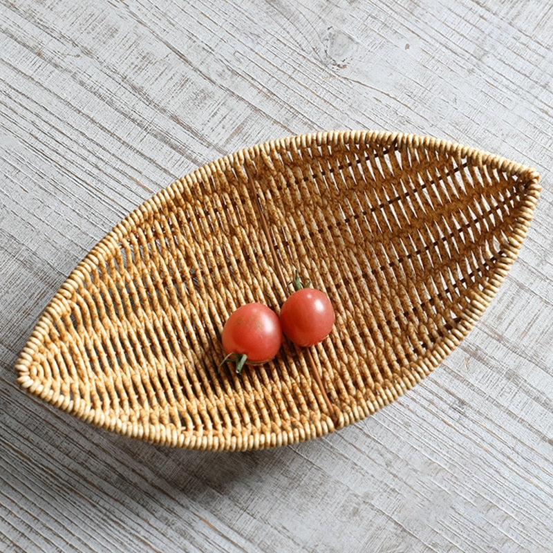 Boat shaped hand woven rattan fruit basket on a kitchen counter