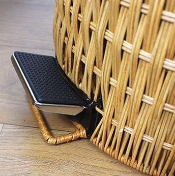 Woven rattan trash can with a foot pedal and a lid