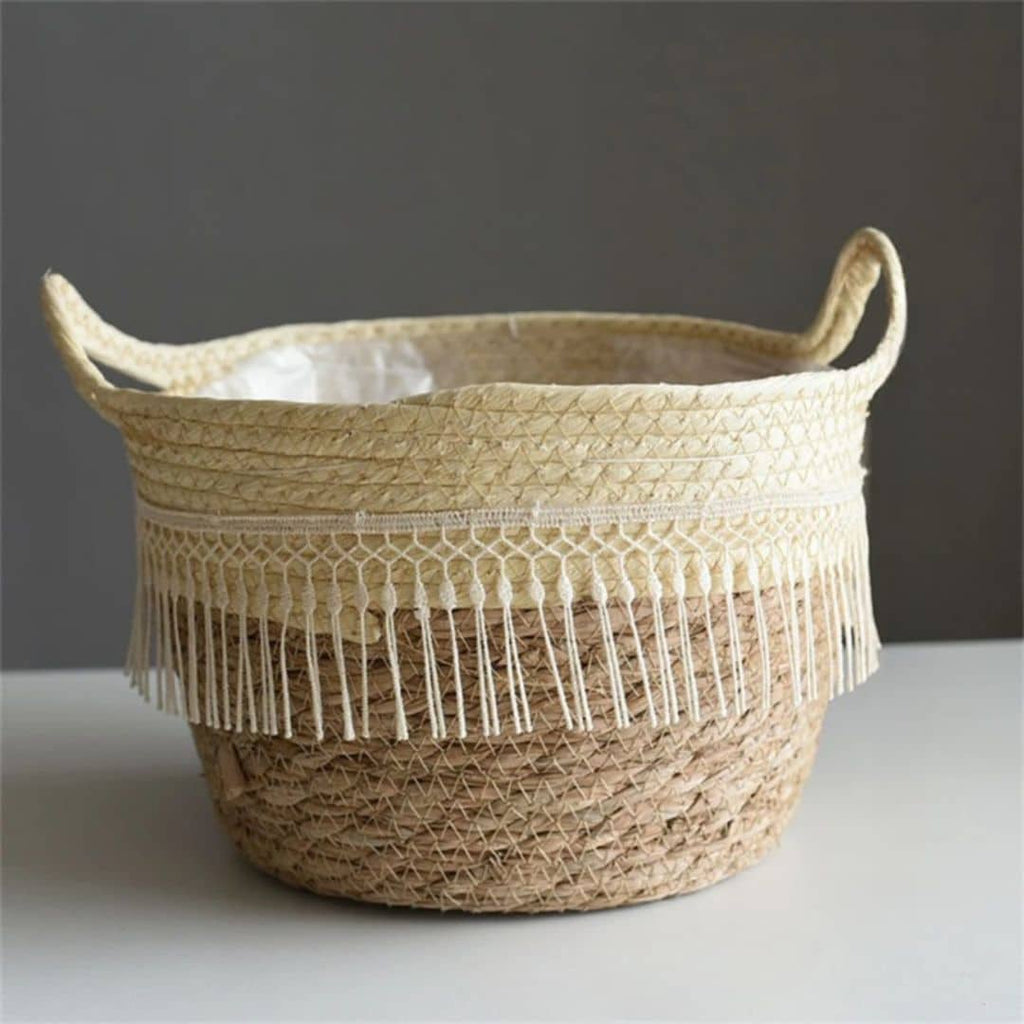 Round hand woven rattan planter trimmed with white pompom fringe
