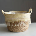 Round hand woven rattan planter trimmed with white pompom fringe