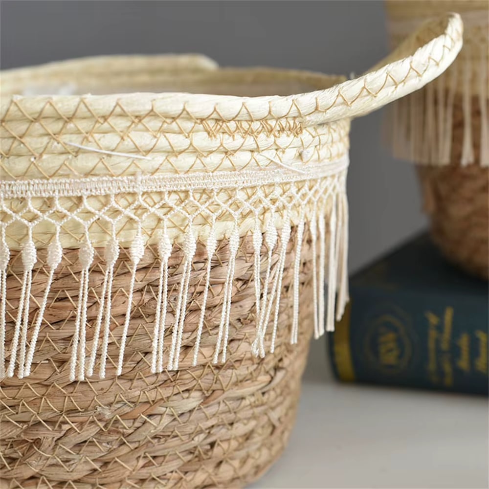 Round hand woven rattan planter trimmed with white pompom fringe