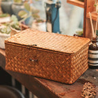 Rectangular woven rattan storage box with a lid, latch and side handles