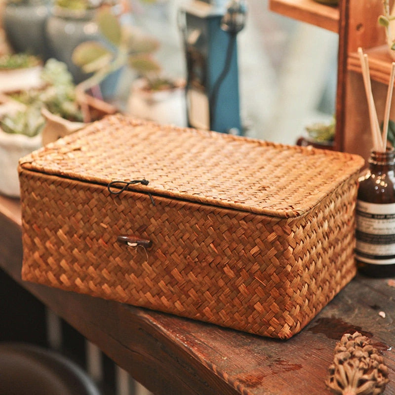Rectangular woven rattan storage box with a lid, latch and side handles