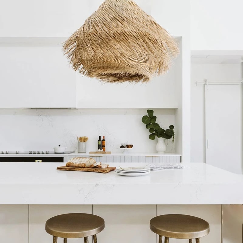 Woven rattan pendant light with three lights and a metal frame